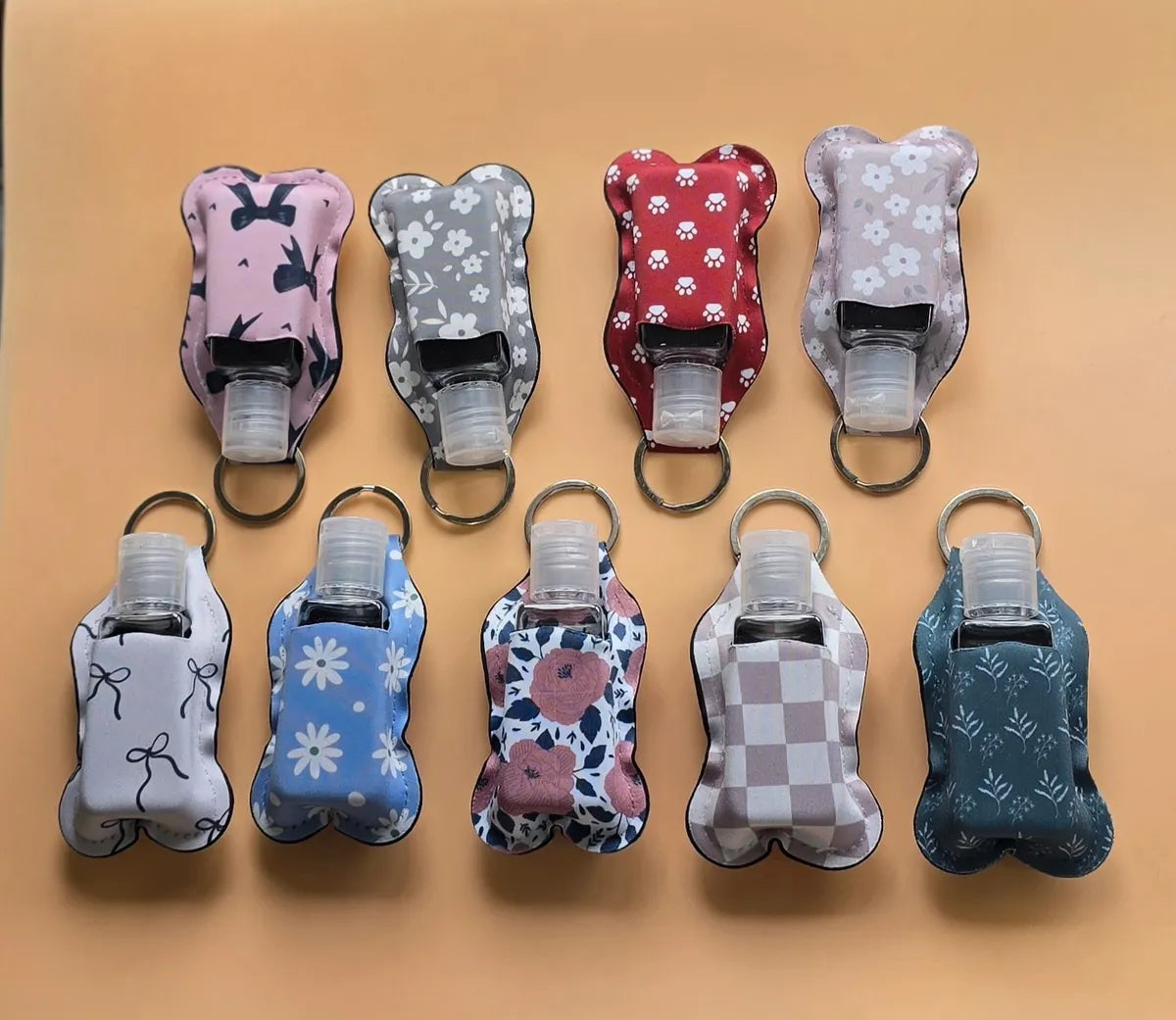 Key chain hand sanitizer holder with refillable bottle