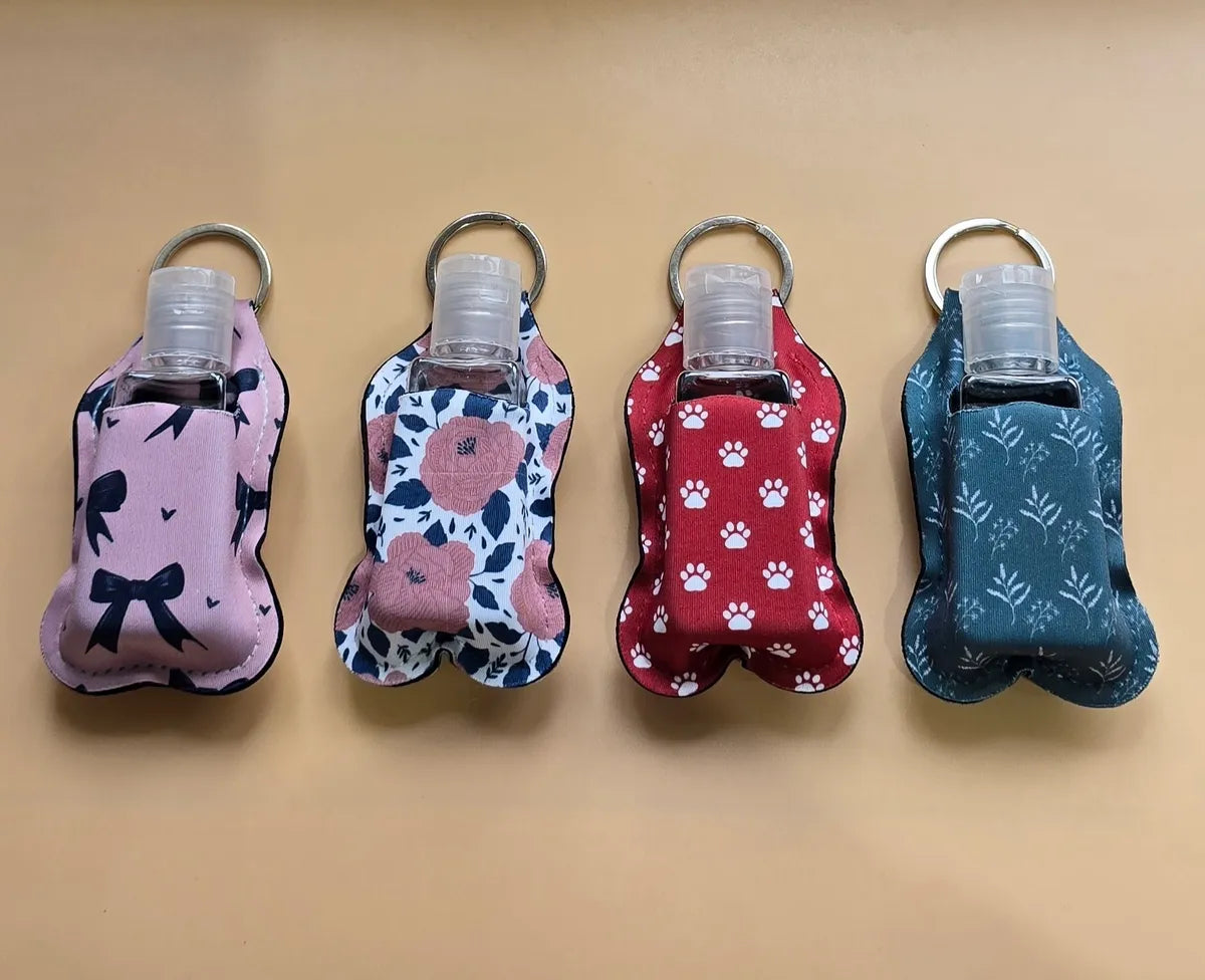 Key chain hand sanitizer holder with refillable bottle
